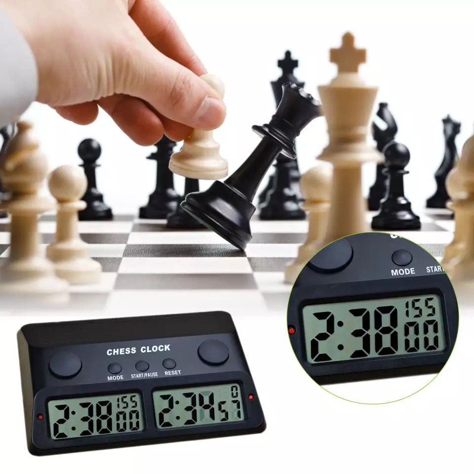 Top-down view of chess tournament timer showing dual turn buttons