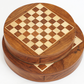 Hands moving a piece on a compact chess board wooden surface