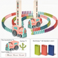 Full product layout displaying the train, a pile of assorted colored dominoes, and the instruction booklet (if visible)
