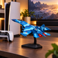 Close-up of blue fighter jet model with red engine detail on stand