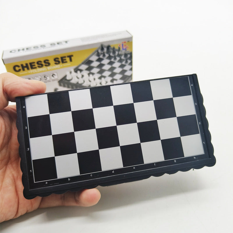 Angled close-up of plastic pieces resting securely on the mini magnetic chess set surface

