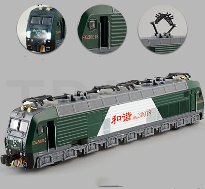 Electric train toy moving along mixed green and blue track layout
