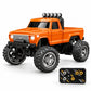 An orange mini RC monster truck with oversized black off-road tires, a black front bumper, roof-mounted light bar, and a separate black remote control controller, shown on a clean white background.